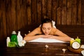 Pretty young woman laying in spa salon with closed eyes and relaxed Royalty Free Stock Photo