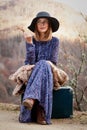 Pretty girl with vintage case on a dirtroad Royalty Free Stock Photo