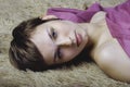 Pretty young woman lying on the carpet Royalty Free Stock Photo