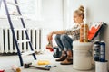 Pretty young woman makes DIY repairs in the house with her own hands. Concept nontraditional gender roles, gender equality, the