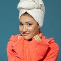 Pretty young woman, morning procedures. Charming girl with towel on her head wearing bathrobe looking at camera like at mirror, Royalty Free Stock Photo