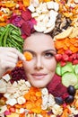 Pretty young woman with organic fruits and vegetables chips. Healthy snack eating Royalty Free Stock Photo