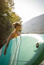 Pretty, young woman paddling on a paddle board on a lake Royalty Free Stock Photo