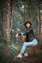 Young woman sitting on the old chair in a forest Royalty Free Stock Photo