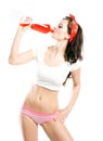 Pretty young woman in panties drinking orange soda