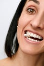 Pretty young woman with a pill in her teeth, isolated against white background. Taking supplement pill into her Mouth Royalty Free Stock Photo