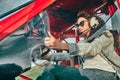 Pretty young woman pilot in headset ready to fly in small airplane Royalty Free Stock Photo