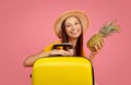 Pretty young woman with pineaaple posing over pink Royalty Free Stock Photo