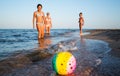 Pretty young woman plays ball with her daughters