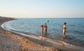 Pretty young woman plays ball with her daughters