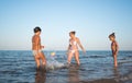 Pretty young woman plays ball with her daughters