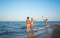 Pretty young woman plays ball with her daughters