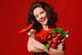 Pretty young woman posing with fresh red vegetables radish chili pepper green leaves lettuce parsley fork and spoon Royalty Free Stock Photo