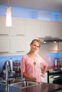 Pretty, young woman in her kitchen, fixing lunch Royalty Free Stock Photo