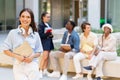 Pretty young woman posing over multiracial group of students Royalty Free Stock Photo