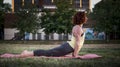 Pretty Young Woman Practicing Yoga in the Park (Up Dog) Royalty Free Stock Photo