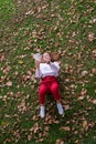 pretty young woman reading a book lying in an autumn garden Royalty Free Stock Photo