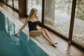 Pretty young woman relaing by the swimming pool