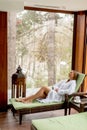 Pretty young woman relaxing by the indoor swimming pool at winter Royalty Free Stock Photo