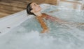 Young woman relaxing in the indoor swimming pool Royalty Free Stock Photo