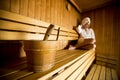 Young woman relaxing in the sauna at spa center