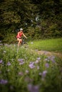 Pretty, young woman riding her mountain bike on a forest path Royalty Free Stock Photo