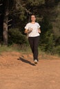 Pretty young women running on the forest road at springtime Royalty Free Stock Photo