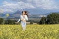 Young woman running happy in a field of yellow flowers Royalty Free Stock Photo