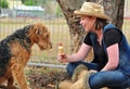 Pretty young woman sharing icecream with dog