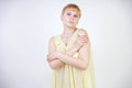 Pretty young woman with short hair and chubby body wearing transparent nightgown and posing on white studio background alone. beau Royalty Free Stock Photo