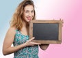 Pretty young woman showing a small chalkboard Royalty Free Stock Photo