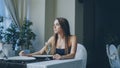 Pretty young woman is sitting alone at table in restaurant, drinking champagne and waiting for her boyfriend. Girl is Royalty Free Stock Photo