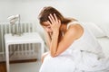 Pretty, young woman sitting on bed Royalty Free Stock Photo