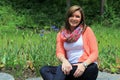 Pretty young woman sitting on rocks Royalty Free Stock Photo