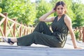 The pretty young woman sitting on a wooden bridge Royalty Free Stock Photo