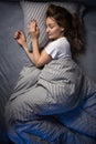 Pretty, young woman sleeping in her bed late in the morning on a weekend Royalty Free Stock Photo