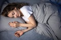 Pretty, young woman sleeping in her bed late in the morning on a weekend Royalty Free Stock Photo