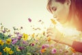 Pretty young woman smelling the flowers Royalty Free Stock Photo