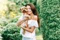 pretty young woman smiling holding small dog puppy yorkshire terrier