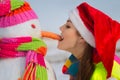 Pretty young woman with a snowman Royalty Free Stock Photo
