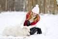 Pretty Young Woman in Winter Forest Walking with her Dog White Samoyed Royalty Free Stock Photo