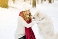 Pretty Young Woman in Winter Forest Park Walking with her Dog White Samoyed Royalty Free Stock Photo