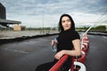 Pretty young woman on the sportsground with a bottle of water in her hands Royalty Free Stock Photo