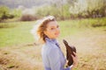 Pretty young woman on spring garten background looking at camera. Female Farmer on farmland. Become organic farmer.