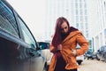 Pretty young woman standing and looking keys of car in her bag outdoors. Royalty Free Stock Photo