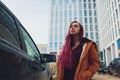 Pretty young woman standing and looking keys of car in her bag outdoors. Royalty Free Stock Photo