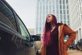 Pretty young woman standing and looking keys of car in her bag outdoors. Royalty Free Stock Photo