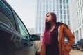 Pretty young woman standing and looking keys of car in her bag outdoors. Royalty Free Stock Photo