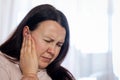 Pretty young woman suffering to strong tinnitus disease, sick female having an ear pain touching her painful head Royalty Free Stock Photo