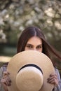 Pretty young woman in a summer garden, casual romantic style with hat Royalty Free Stock Photo